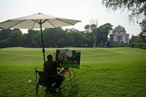 An artist paints a Mughal-era heritage monument at Delhi Golf club during the DP World India Championship