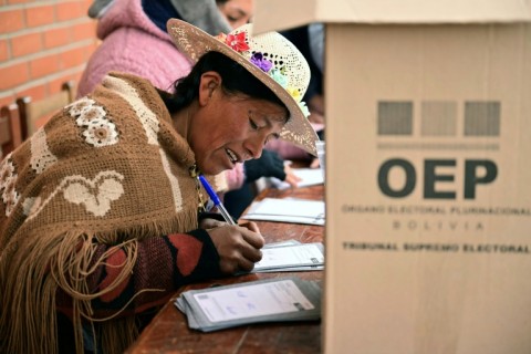 An Aymara woman prepares to cast her vote during the presidential runoff election, in Laja, some 30 km west of La Paz, on October 19, 2025