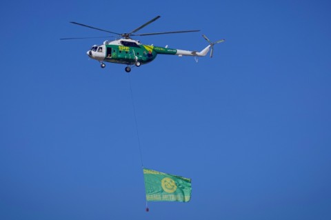 A helicopter hovered overhead displaying the president's poster where Hassan was due to appear in Stone Town