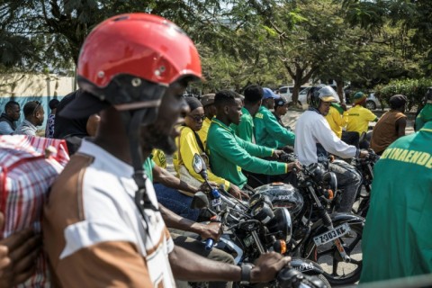 Lorries, buses and motorbikes packed with supporters weaved through town to see the leader