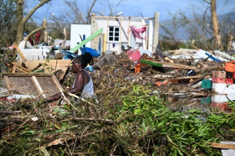 A man stands next to a damaged house after the passage of Hurricane Melissa in Boca de Dos Rios village, Santiago de Cuba province, Cuba