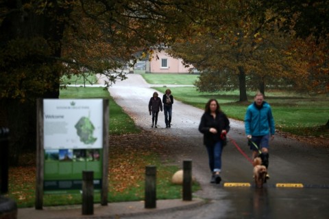 Members of public walk near the entrance to the Royal Lodge in Windsor Great Park