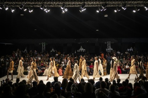 Models wearing outfits by Kenyan-Indian designer Ria Ana Sejpa, known for incorporating banana fibre and coffee grounds into her work, walk the runway during Lagos Fashion Week