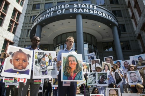 People hold signs during a vigil in Washington DC for victims of the crash of Ethiopian Airlines Flight ET302