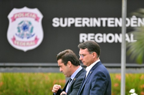 Senator Flavio Bolsonaro (R), son of former Brazilian president Jair Bolsonaro, leaves the Federal Police headquarters in Brasilia where his father is being held