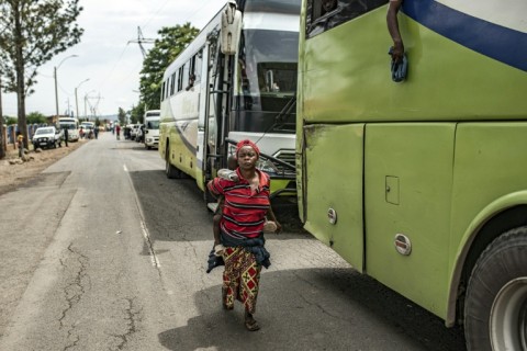 A woman who fled the fighting for nearby Rwanda holds her child