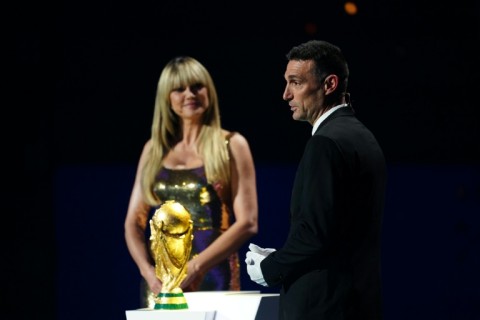 Argentina coach Lionel Scaloni speaks on stage next to the World Cup trophy during Friday's draw for the 2026 finals
