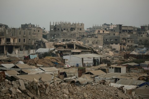 Displaced Palestinians set up their tents surrounded by rubble from buildings destroyed by the Israeli military in central Gaza