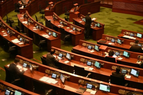 People pay their respects for the victims of a deadly fire at the Wang Fuk Court residential estate in Hong Kong's Tai Po district