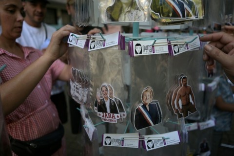 A woman sells stickers featuring images of Chilean presidential candidate Jeannette Jara of the Unidad por Chile coalition and former Chilean President Michelle Bachelet in Santiago