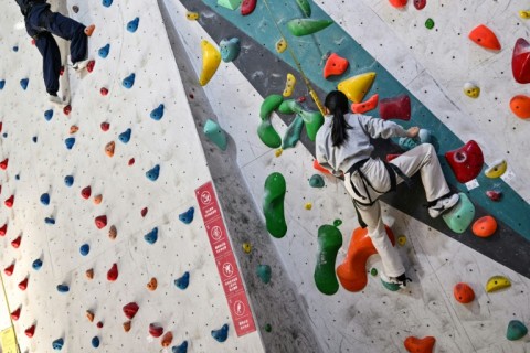 Estella climbs an indoor wall in Shanghai during a break from homeschool lessons