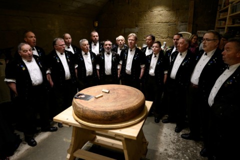 Yodellers performing in front of a giant round of Emmental cheese as part of a university experiment