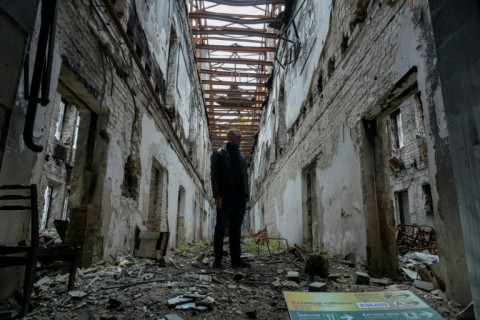 Kostiantyn Kosik in a bombed out building near his university in Irpin