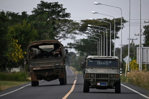 Military vehicles on a road in the Thai border province of Surin