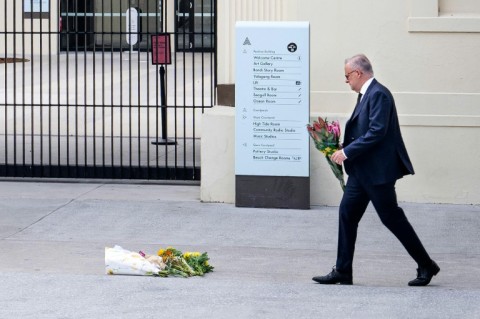 Australia's Prime Minister Anthony Albanese lays flowers at the Bondi Pavillion in Sydney after a mass shooting that killed 15 people