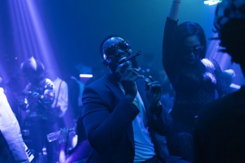 Ozumba Mbadiwe, one of the owners of 2:45 nightclub, dances as he smokes a cigar