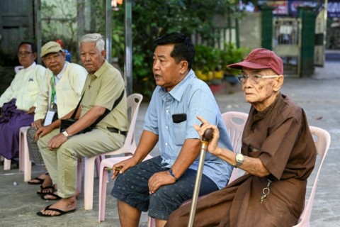 People wait after voting at a polling station in Myanmar's Yangon