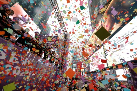 A security guard walks past a New Year's greeting banner in Hanoi