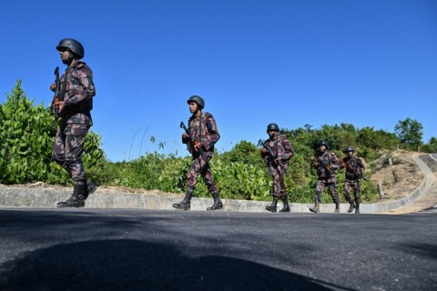 Border Guard Bangladesh (BGB) personnel patrol near the Bangladesh-Myanmar frontier in Bandarban district