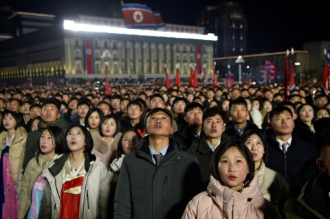 People watch a flag-raising ceremony to welcome in the new year at Kim Il Sung Square in Pyongyang on January 1, 2026