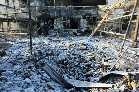 A Ukrainian rescuer works at the site of an air strike in Kharkiv