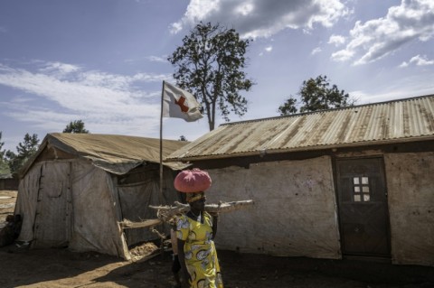 A woman carries firewood in a displacement camp in eastern Democratic Republic of Congo, where UNICEF warned of 'alarming levels' of sexual violence against children