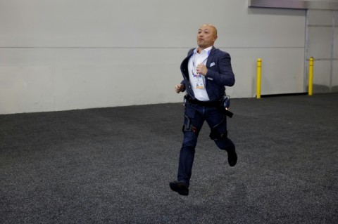 A visitor at CES tries out an exoskeleton from Dnsys