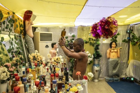 Seen here at last year's Vodun Days a proponent of Voodoo rites makes offerings to aquatic deity Mami Wata