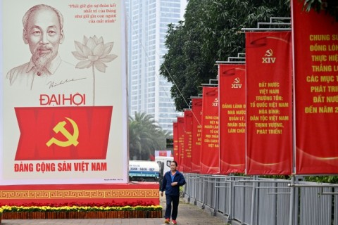 A man walks past a billboard for the 14th Congress of the Communist Party of Vietnam outside the National Convention Center in Hanoi on January 15, 2026
