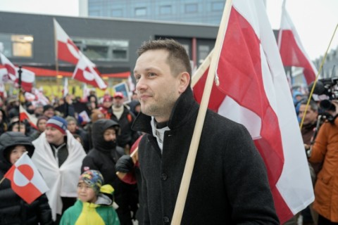 Greenland's leader Jens-Frederik Nielsen holds a Greenlandic flag as he attends a demonstration to the US consulate in Nuuk, Greenland over the weekend, as Greenlanders admit they cannot fight the United States but have no wish to be part of it