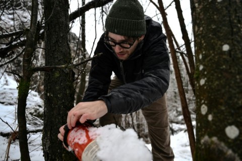 Doctoral student Marco Granata checks a camera trap used to monitor small mustelids, such as ermines, in the Maritime Alps.
