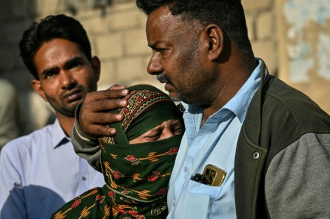 Pakistan rescuers scour blaze site for dozens missing