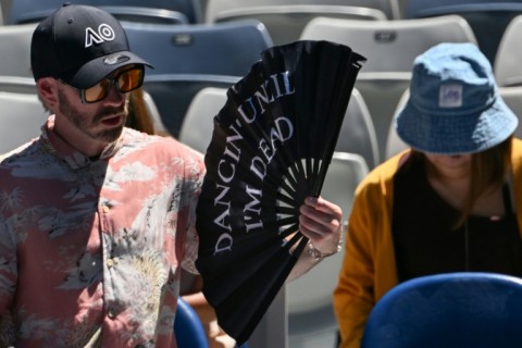 A spectator uses a fan on day seven of the Australian Open