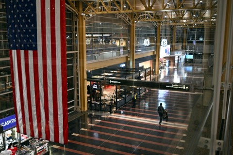 A passenger walks through the check-in area of Ronald Reagan National Airport in Washington, DC, on January 24, 2026, after thousands of flights across the United States were cancelled due to a winter storm