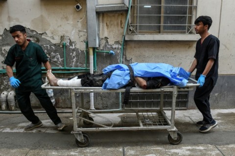 Paramedics shift an injured man at a hospital in Quetta following an attack by Baloch separatists