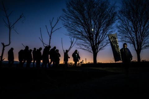 The few dozen men, most in their sixties, were headed to Nagano's Lake Suwa in search of a phenomenon called "God's Crossing"