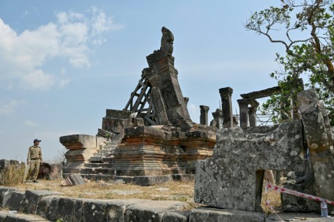 A police officer inspects a damaged section at the Preah Vihear temple in northern Cambodia