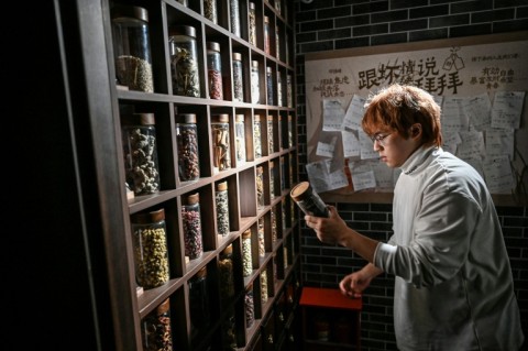 Instead of shelves of alcohol, apothecary drawers are stocked with ingredients like goji berries and angelica root