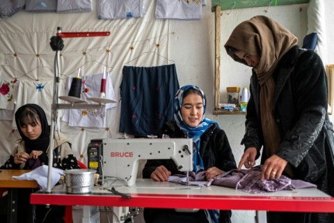 Afghan women embroider scarves and clothes at a boutique in Bamiyan