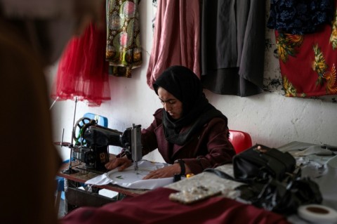 Rahima Alavi embroiders a scarf at her boutique in Bamiyan
