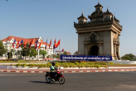 A motorist drives past a banner that translates as "Congratulations to the election of representatives to the 10th National Assembly"