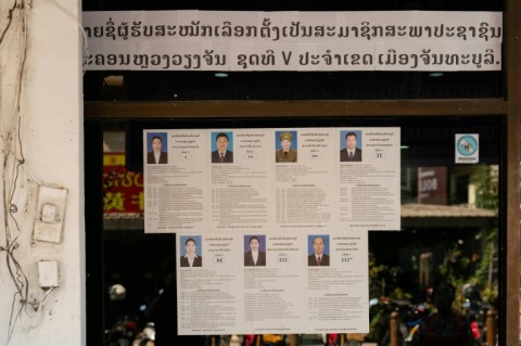Names and photos of a list of candidates for the Fifth Vientiane People's Councils in Chanthaburi District are displayed outside a village office ahead of the election in Vientiane