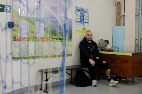 Ukrainian veteran Volodymyr with call sign 'Arkhyp' sits on a bench at the venue of a football tournament in Pavlograd on January 24, 2026, amid the Russian invasion of Ukraine