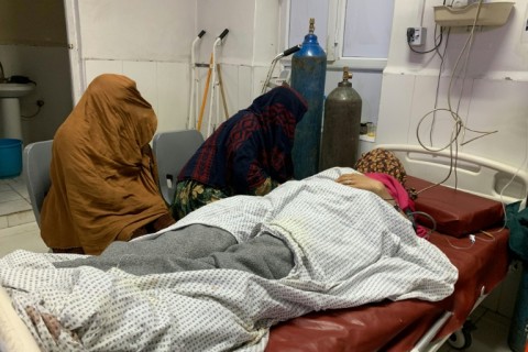 A wounded Afghan woman receives treatment at a hospital in Jalalabad, after an overnight Pakistani mortar shell hit a camp for people returning from Pakistan