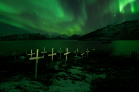A cemetery in Kapisillit, Greenland, illuminated by the northern lights on February