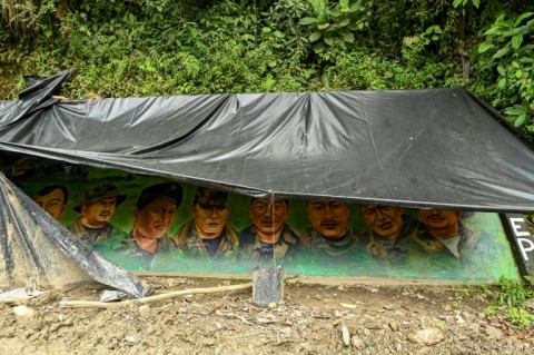 A mural painted by the Jaime Martinez front of FARC dissidents is pictured along a road in the Naya region of Colombia ahead of legislative elections