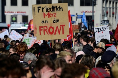 Students demonstrate with a placard reading Chancellor 'Friedrich Merz to the front'
