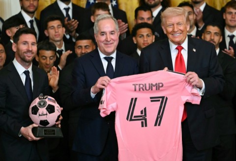 Inter Miami's Argentine superstar Lionel Messi (L), owner Jorge Mas and US President Donald Trump pose with a jersey and a signed ball during a White House event honoring the squad
