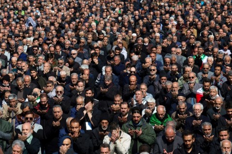 Muslims take part in Friday noon prayers at the compound of the Mosalla mosque in Tehran