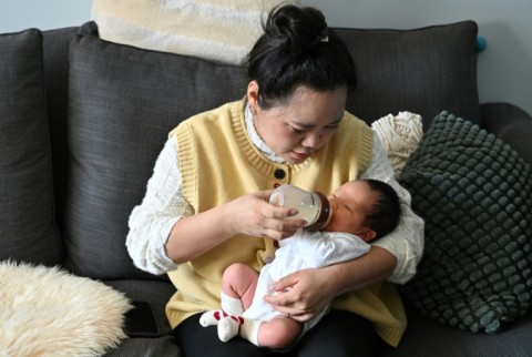 Zhang Xiaofei gives milk to her newborn baby Zhu Wanning in Langfang, northern China's Hebei province